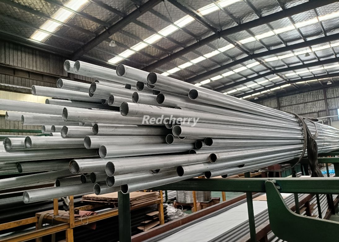 Extrusion machine forming aluminum finned tubes with controlled fin spacing for HVAC heat exchangers.